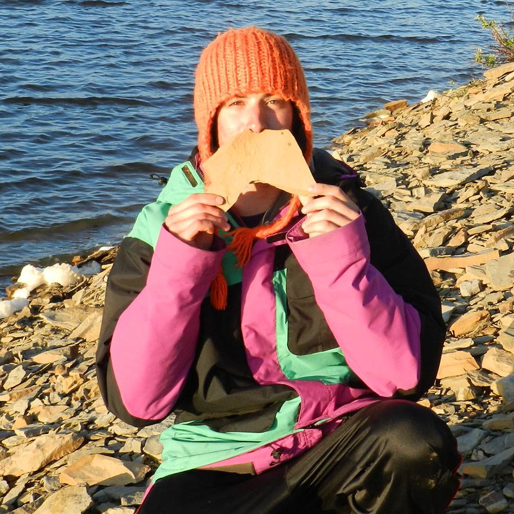 Julien holds up a rock to the camera.